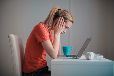 Woman looking at computer trying to make a decision