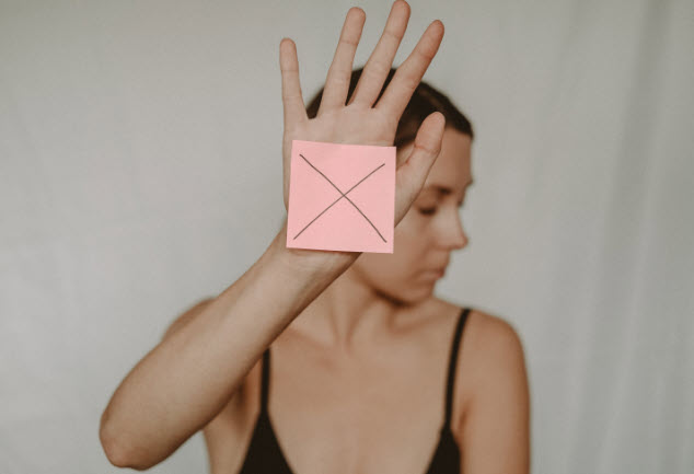 pexels-anete-lusina-5723269_crop_small image of woman holding up hand of rejection